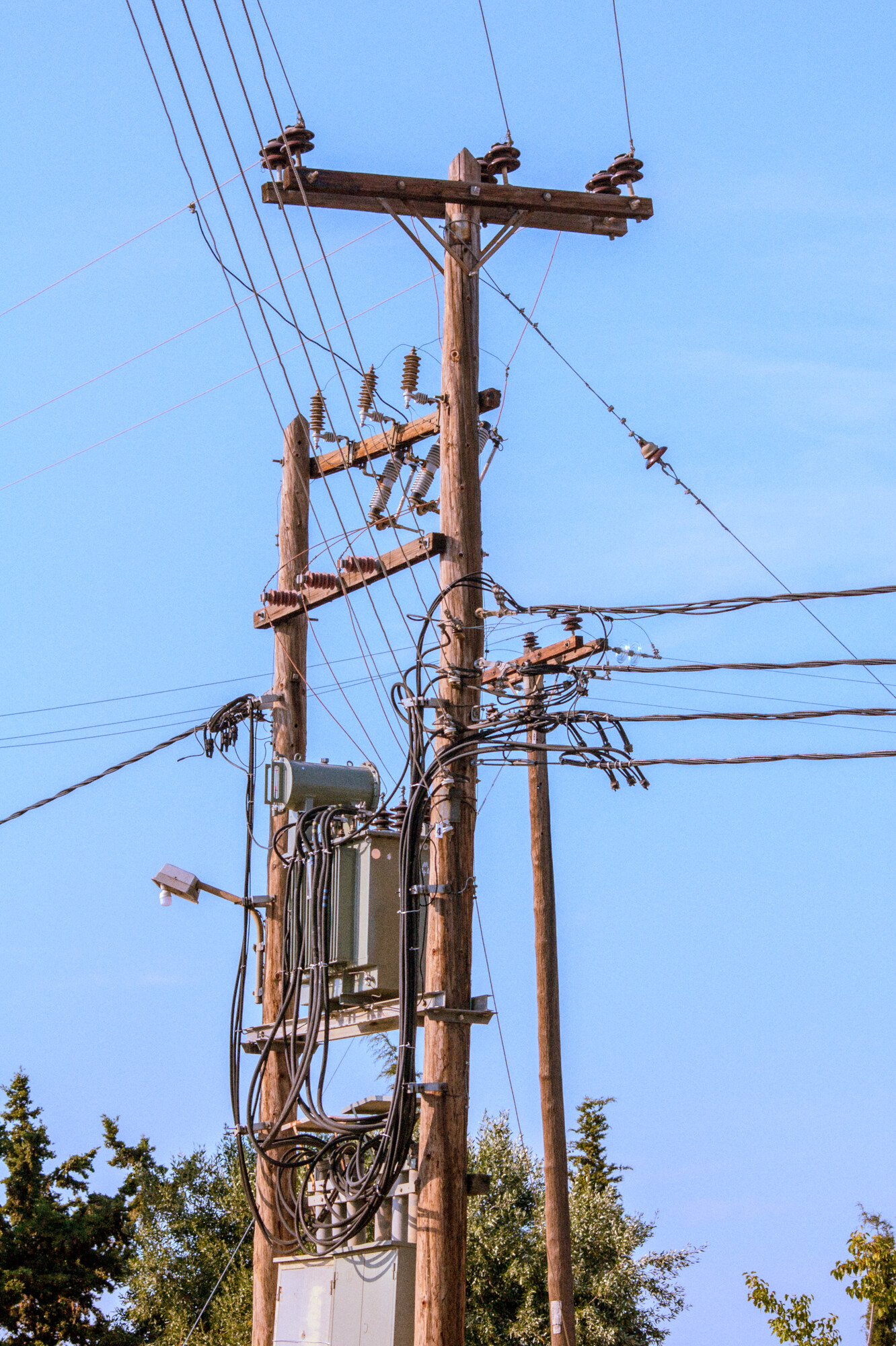 Wooden utility poles with transformer and power lines
