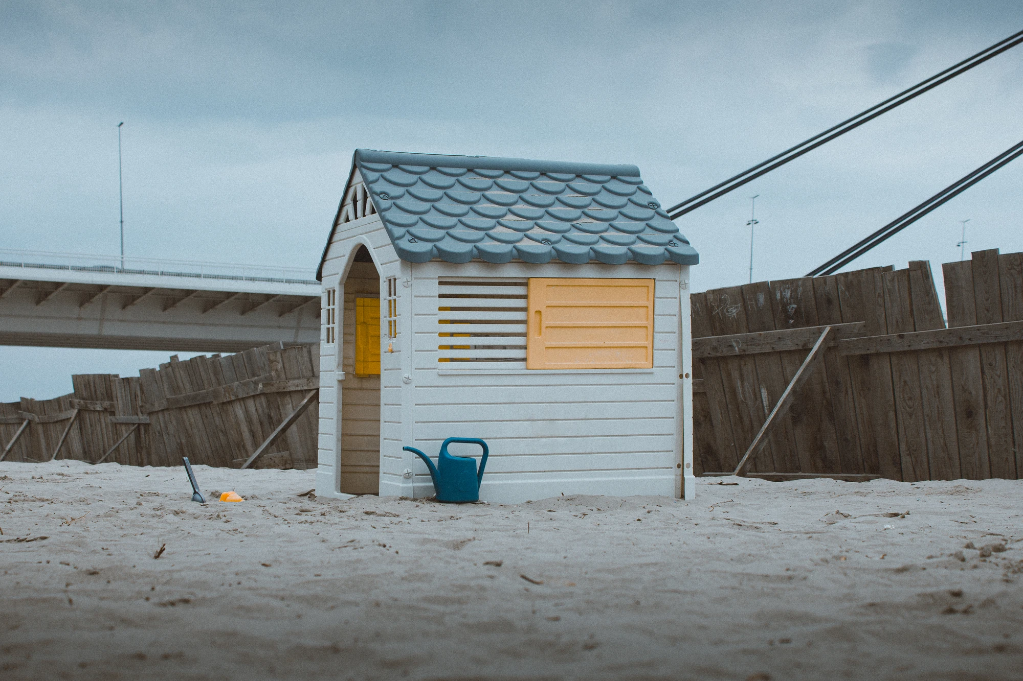 A child's playhouse sitting alone on a beach