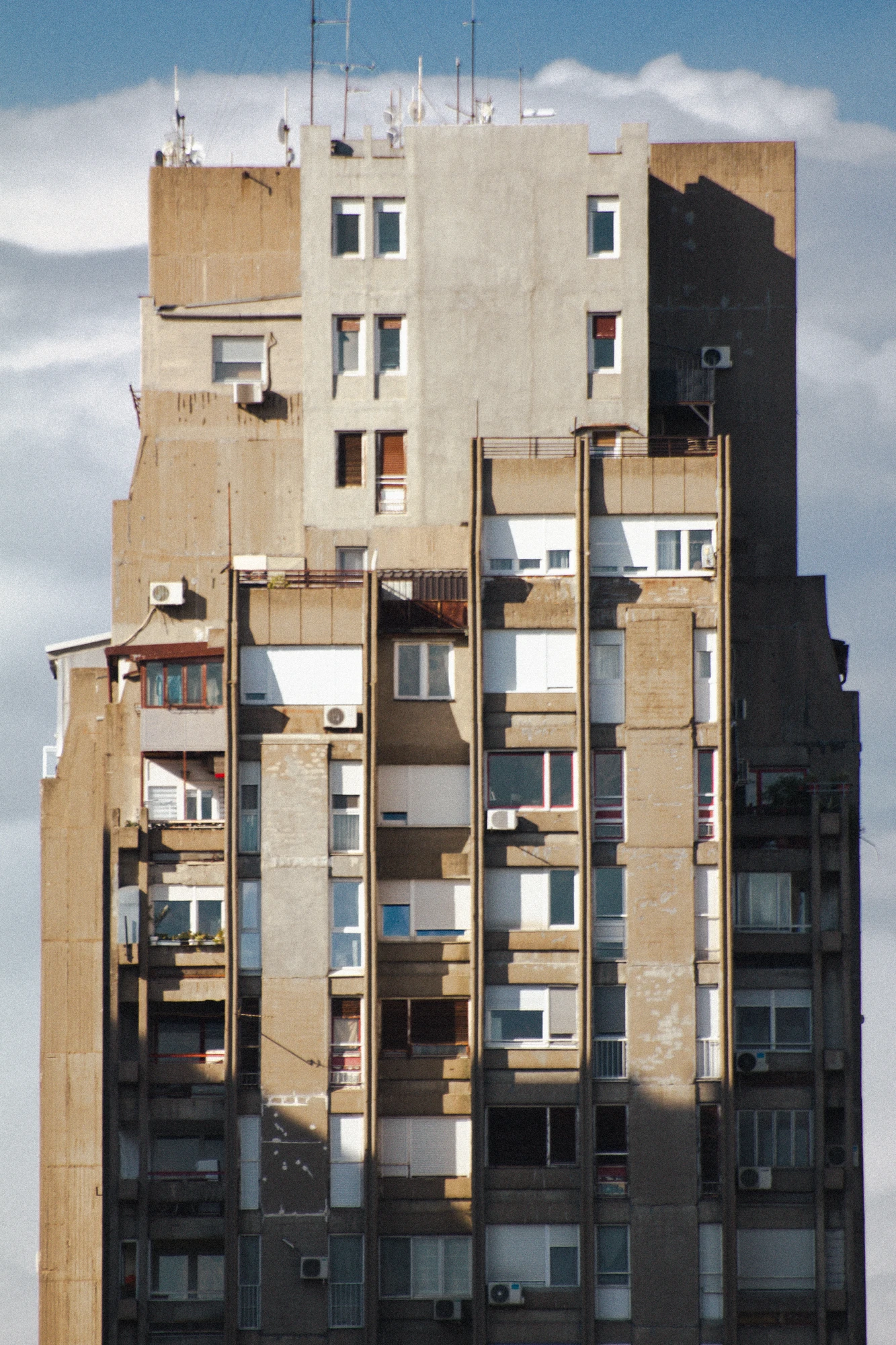 A huge concrete skyscraper with many windows