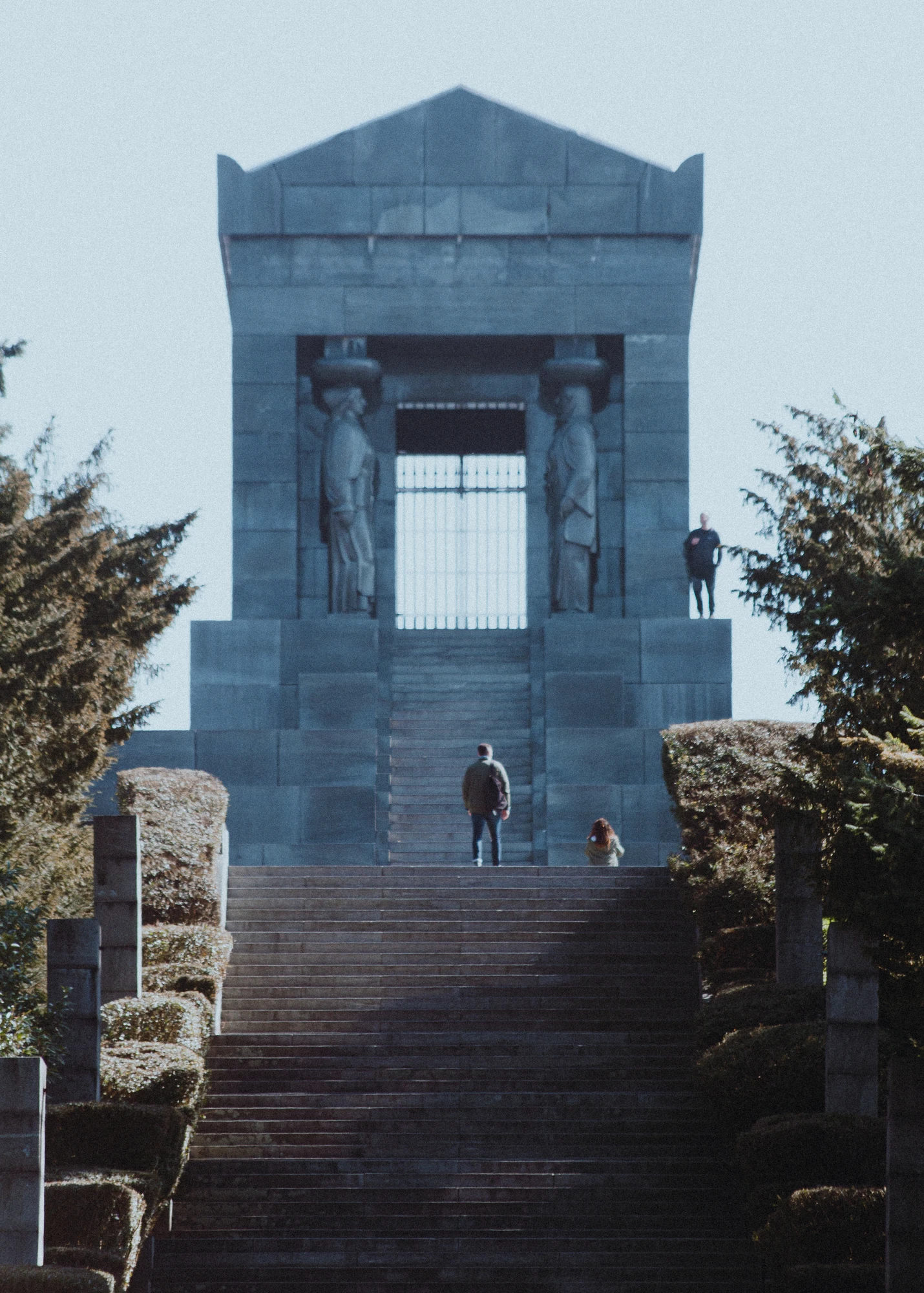 A man standing on the steps of a monument