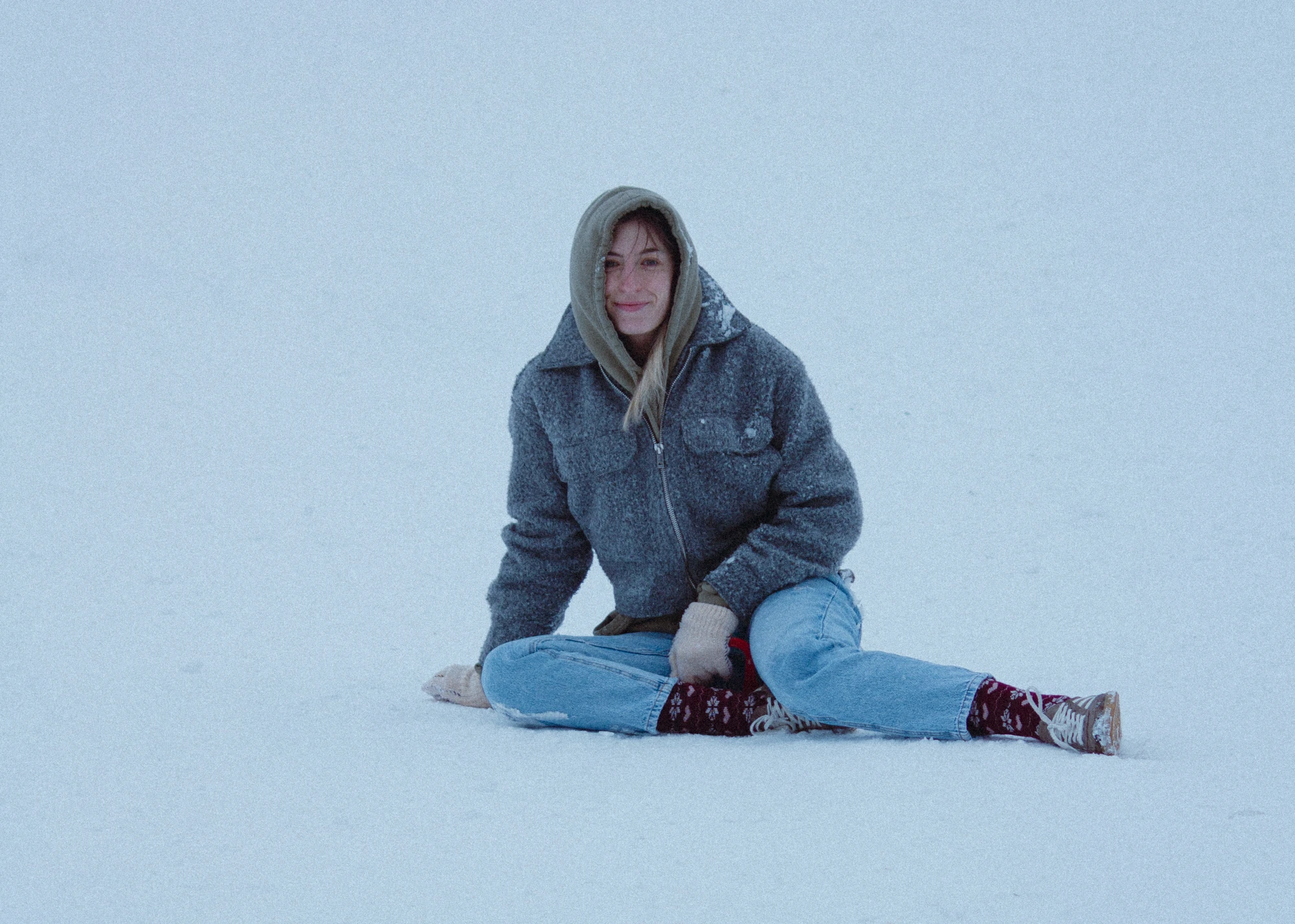 A woman sitting in the snow