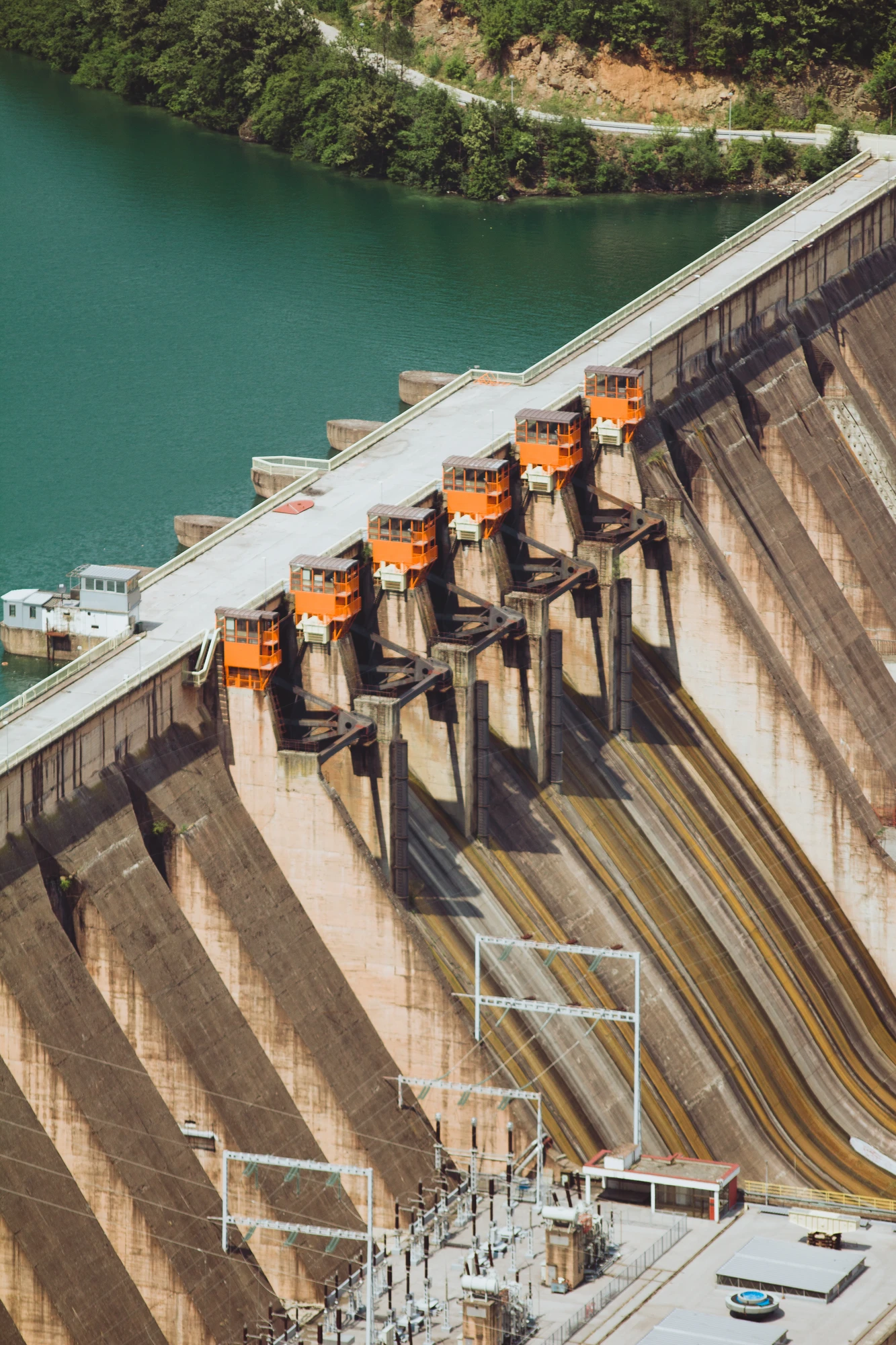 A massive concrete dam wall and a lake