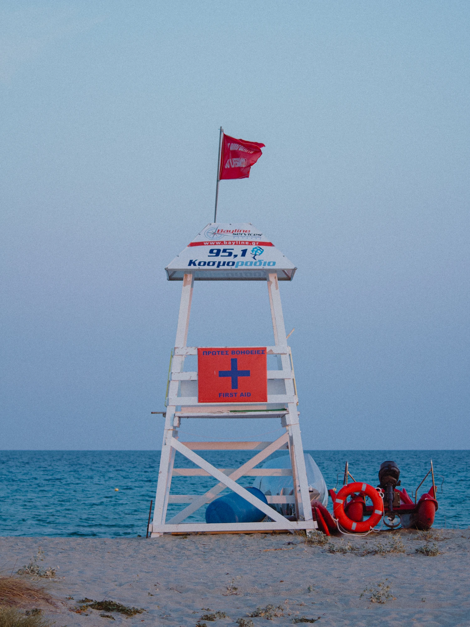 White lifeguard tower on a beach at dusk