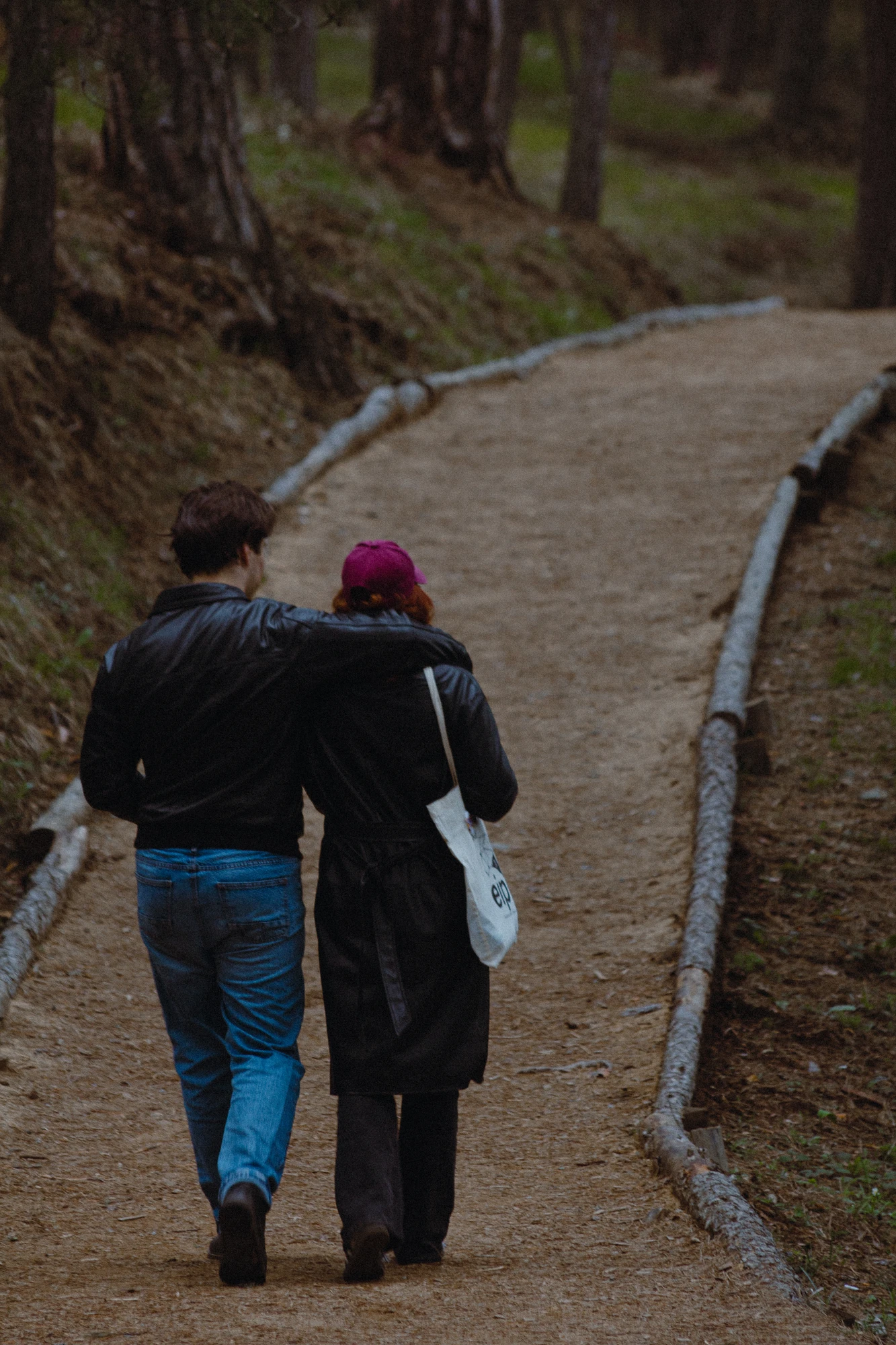 A couple walking down a path in the woods