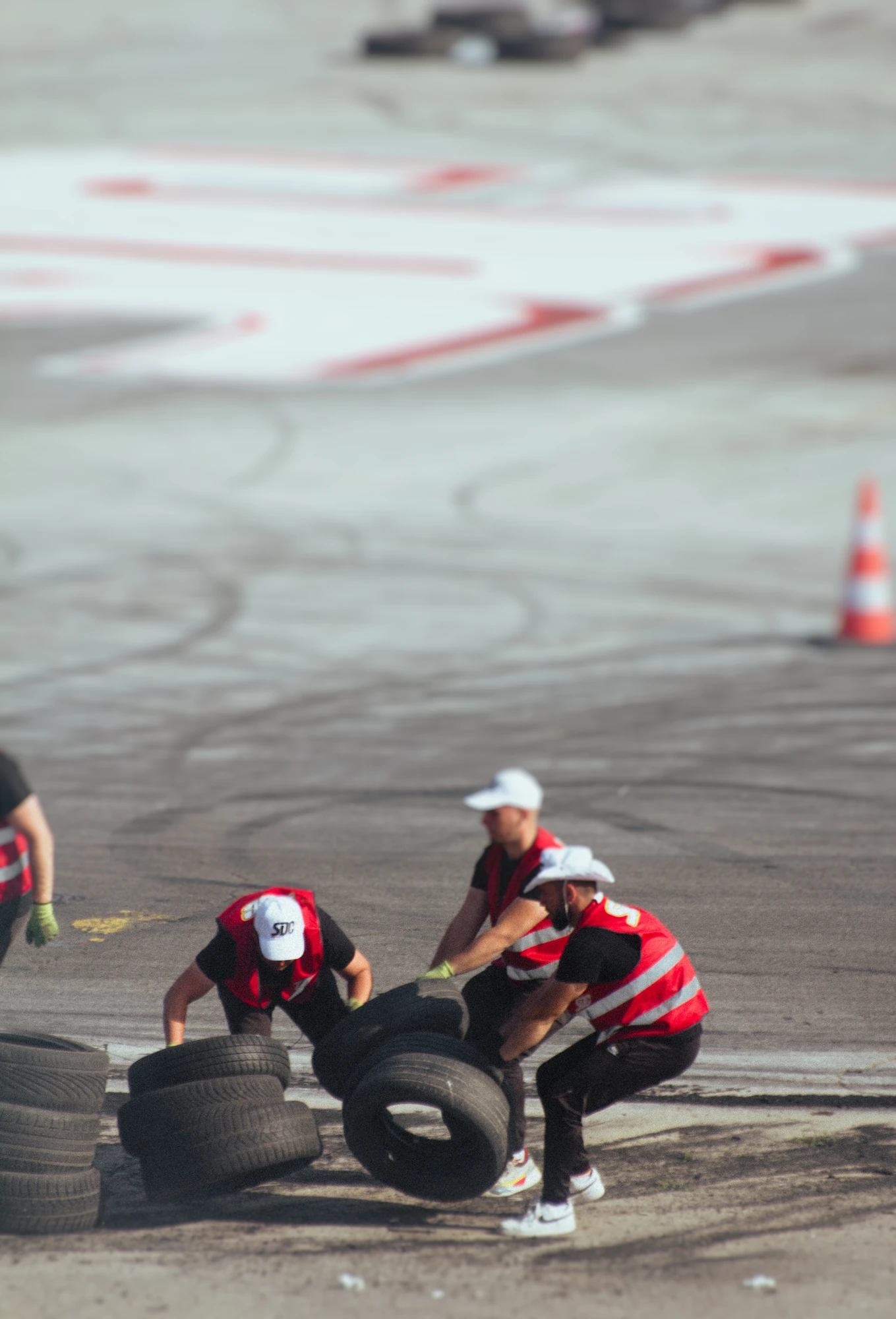 Race staff fixing a broken tyre barier