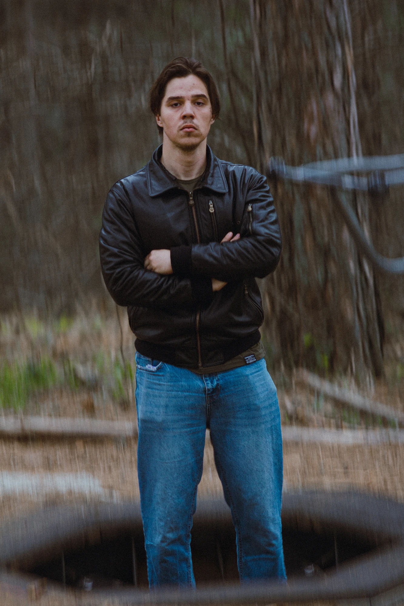 A man jumping on a trampoline in the woods