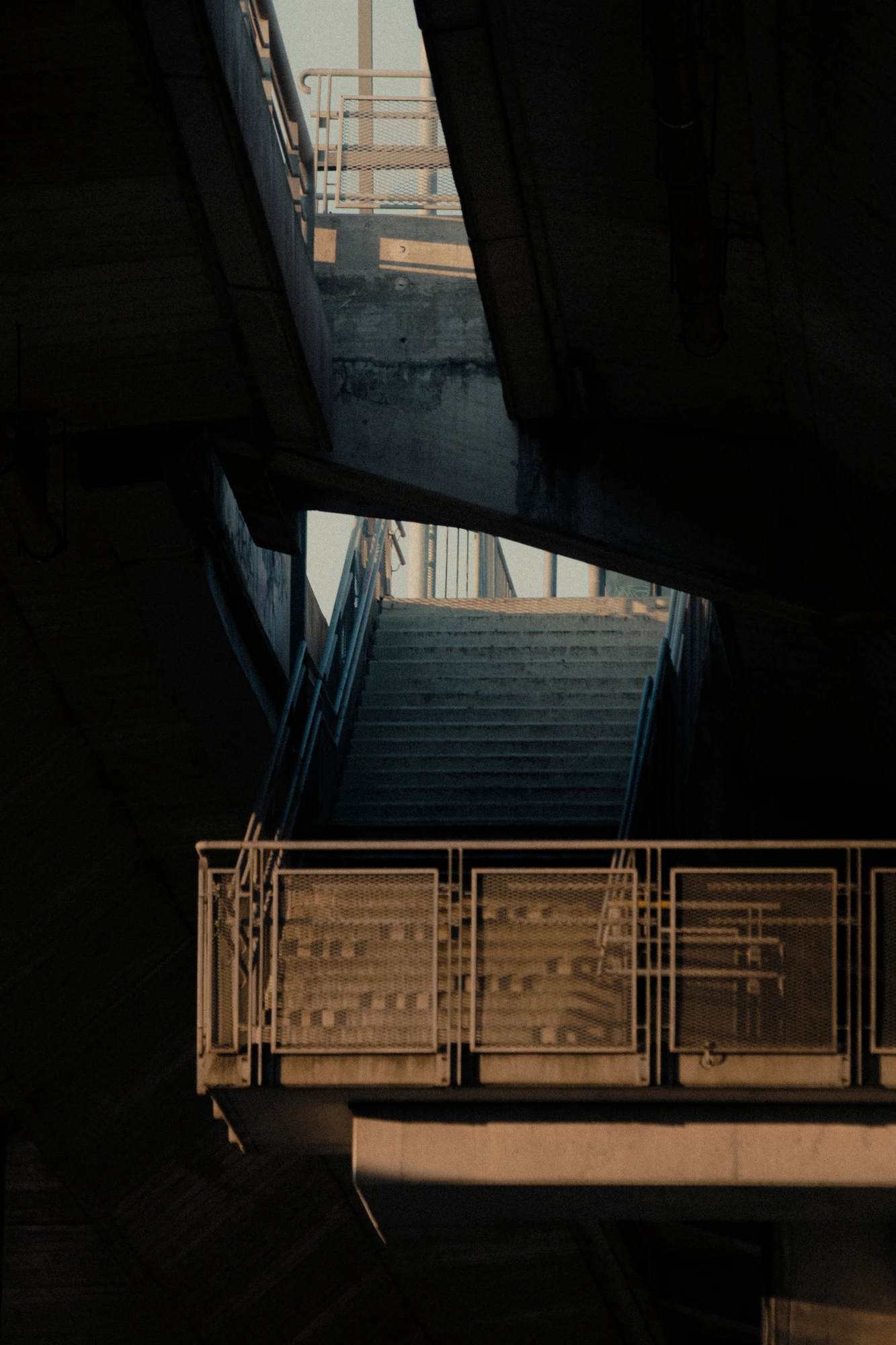 Concrete underpass with metal walkway and stairs