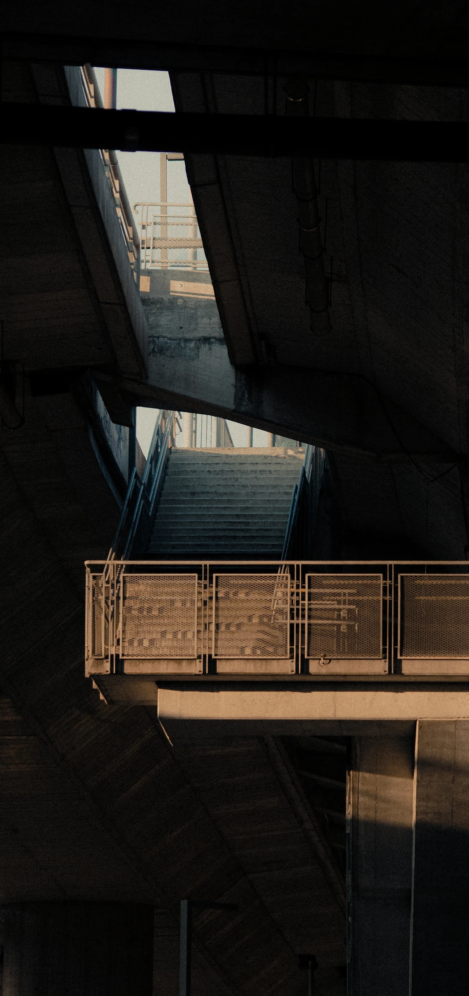 Concrete underpass with metal walkway and stairs