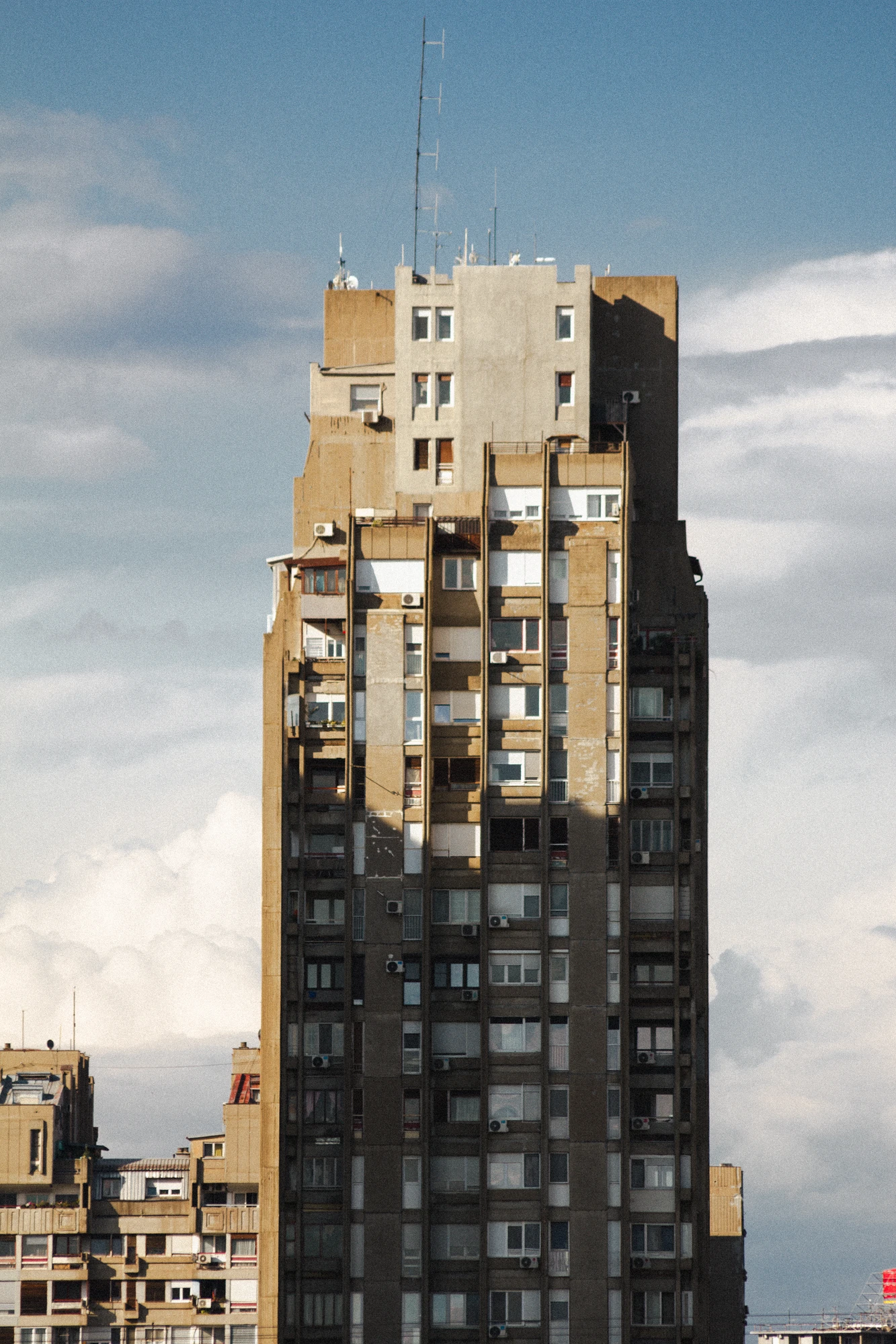A huge concrete skyscraper with many windows