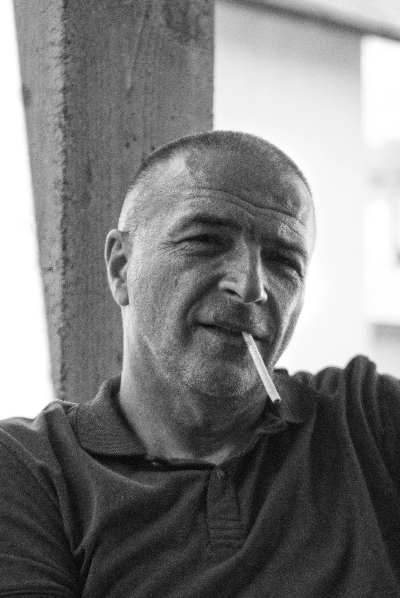 A portrait of a person with a cigarette
