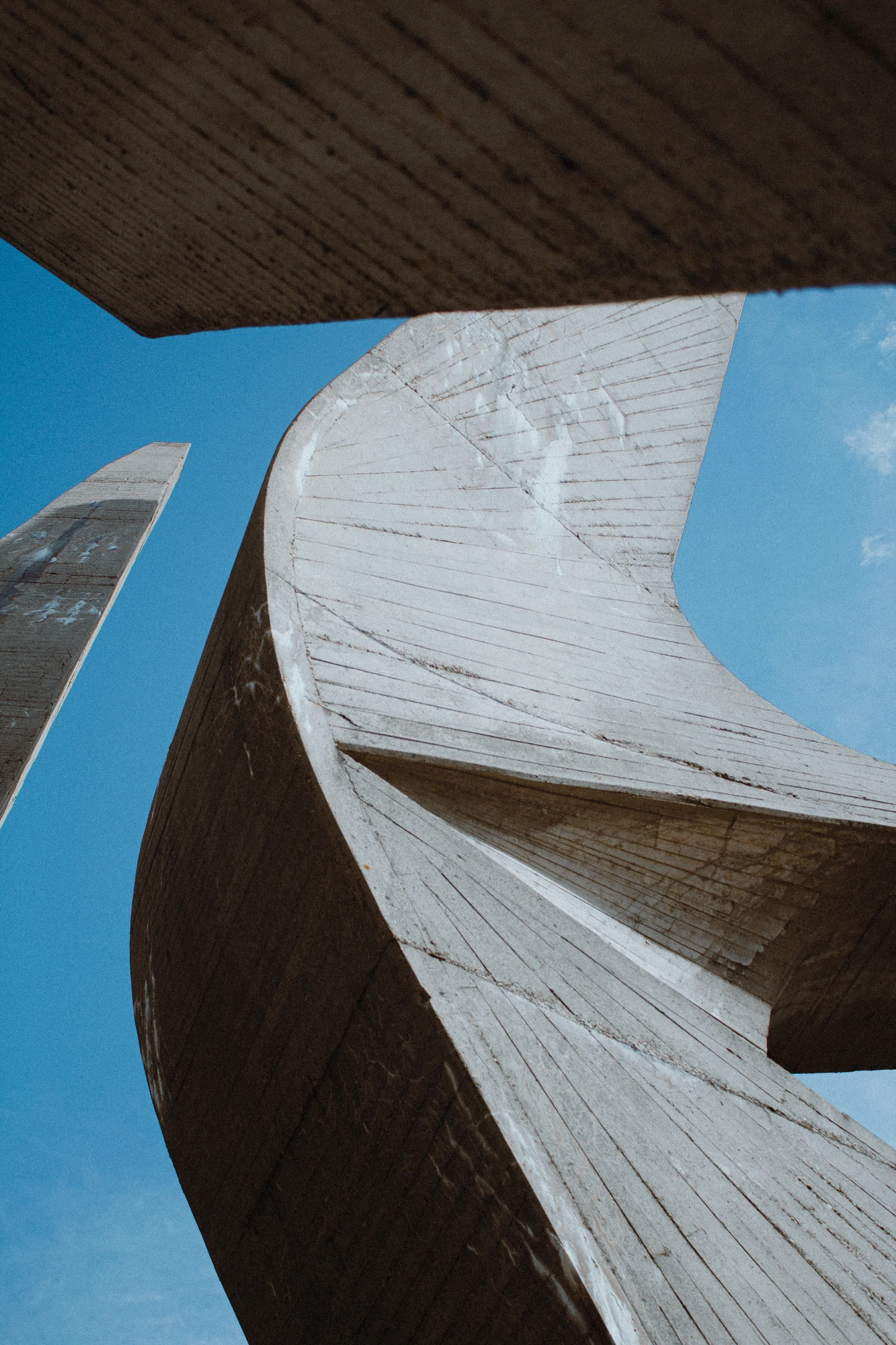 A large concrete memorial with a sky background
